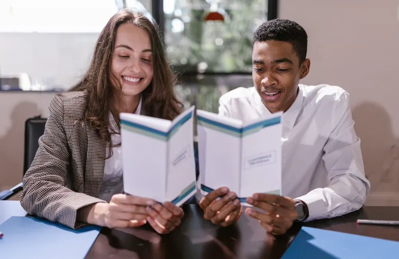 Two colleagues reviewing a document together
